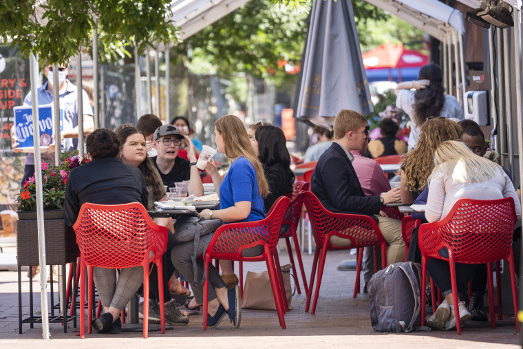 People eat outside during the lunch hour at a restaurant on Pennsylvania Avenue in the Capitol Hill neighborhood on May 21, 2021 in Washington, DC.